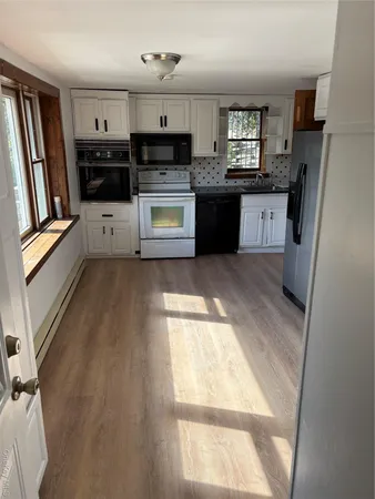 a kitchen with stainless steel appliances a stove a refrigerator and a sink