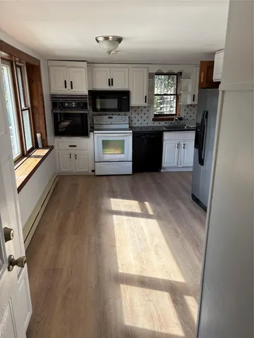 a kitchen with stainless steel appliances a stove a refrigerator and a sink