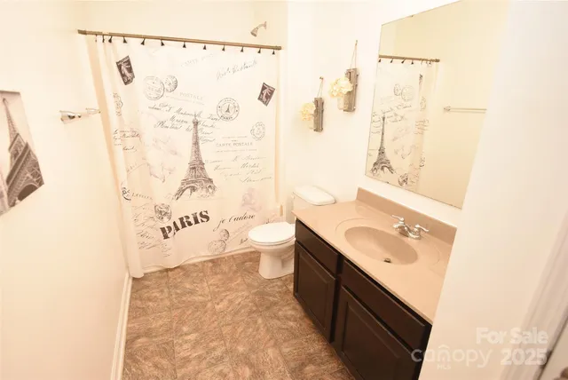 a spacious bathroom with a sink toilet and shower