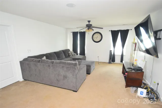 a living room with furniture and a clock