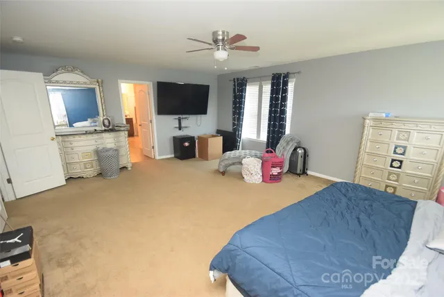 a bed room with furniture and a flat screen tv