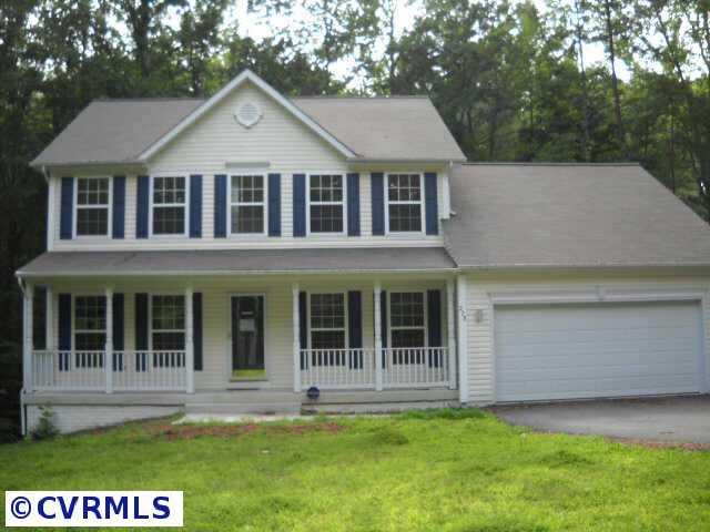278 Cedar Ridge Drive Ruther Glen, VA 22546 - Photo 1 of 7 a front view of a house with a garden and yard