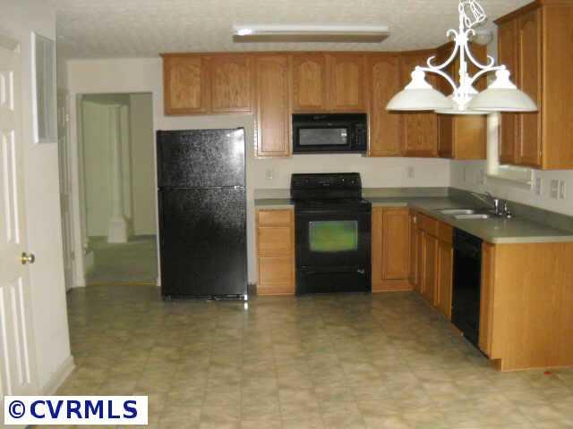 278 Cedar Ridge Drive Ruther Glen, VA 22546 - Photo 4 of 7 a kitchen with stainless steel appliances granite countertop a refrigerator a stove and a sink