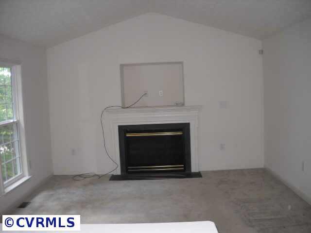 278 Cedar Ridge Drive Ruther Glen, VA 22546 - Photo 5 of 7 a view of an empty room with a fireplace