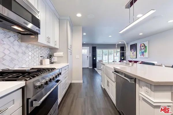 a kitchen with stainless steel appliances granite countertop a stove and a sink