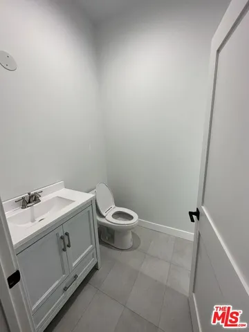 a bathroom with a toilet sink and vanity