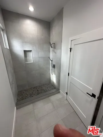 a bathroom with a shower and a sink