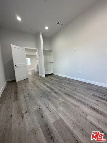 a view of a room with wooden floor and window
