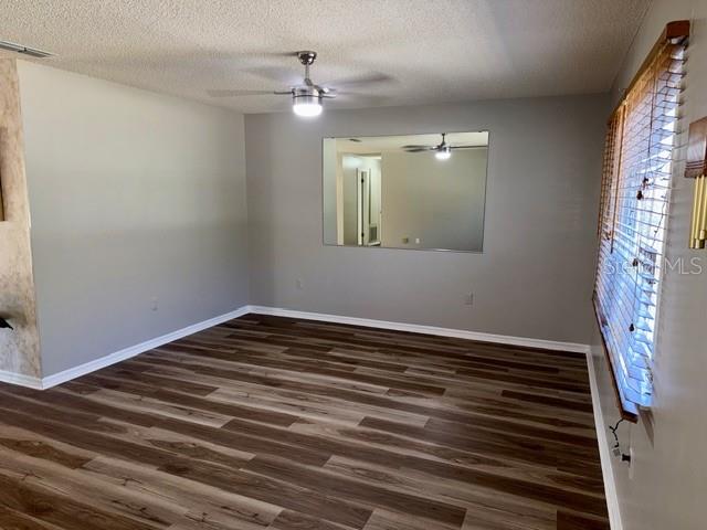 10740 Southwest 62nd Avenue Road Ocala, FL 34476 - Photo 3 of 19 a view of a room with wooden floor and fan