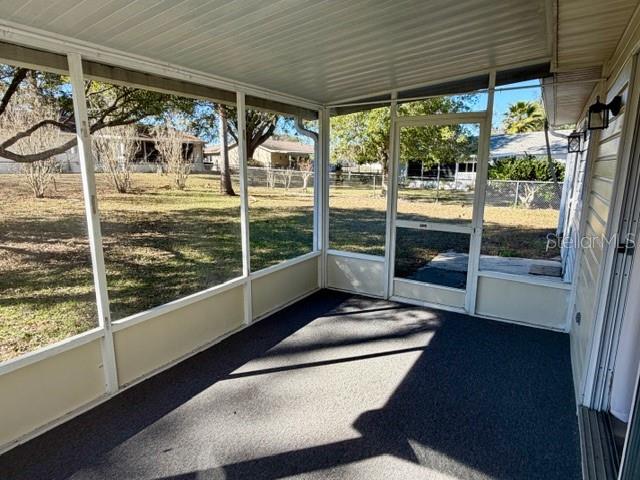 10740 Southwest 62nd Avenue Road Ocala, FL 34476 - Photo 8 of 19 a view of a porch with furniture and floor to ceiling windows