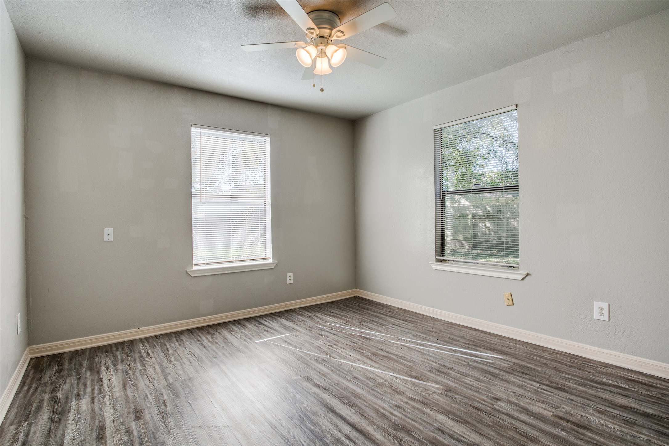 106 Verna Spur, Unit B Georgetown, TX 78628 - Photo 14 of 25 Well-lit room features handsome wood-look flooring and a functional ceiling fan.