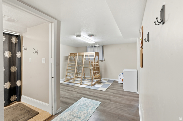 270 East 700 North Logan, UT 84321 - Photo 19 of 42 Spacious room featuring wood-finish flooring, light neutral wall tones, and recessed lighting