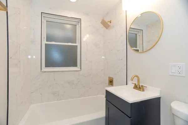 a bathroom with a toilet sink and mirror