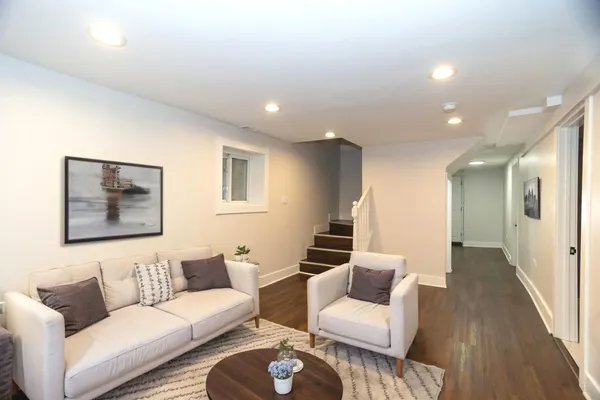 a living room with furniture and a wooden floor