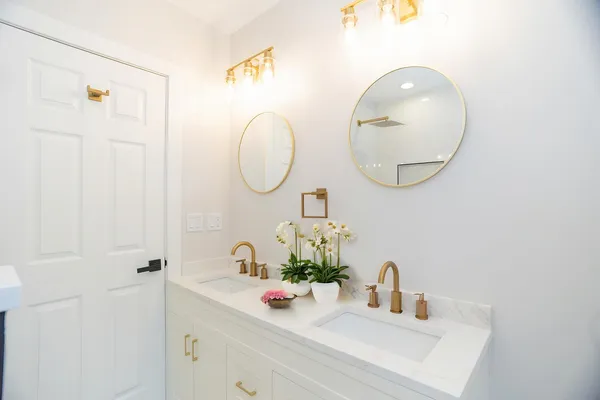a bathroom with a sink mirror and vanity