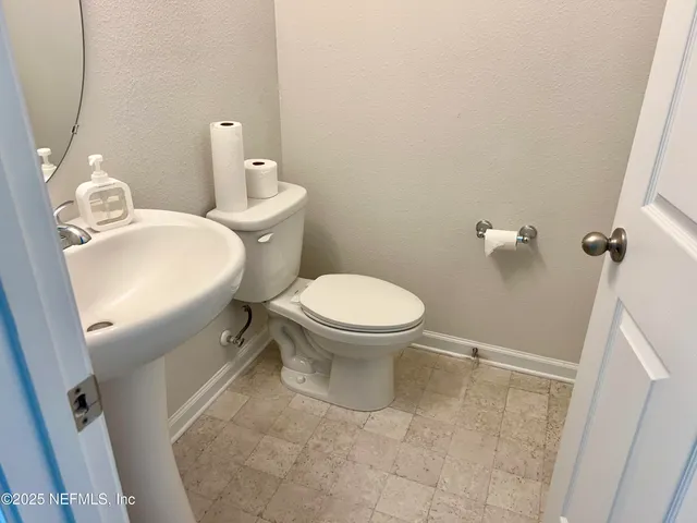 a bathroom with a sink toilet and a mirror