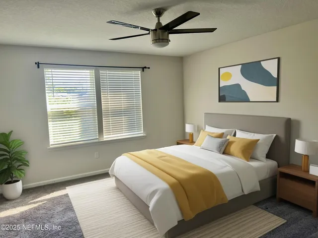 a bedroom with a large bed and a potted plant