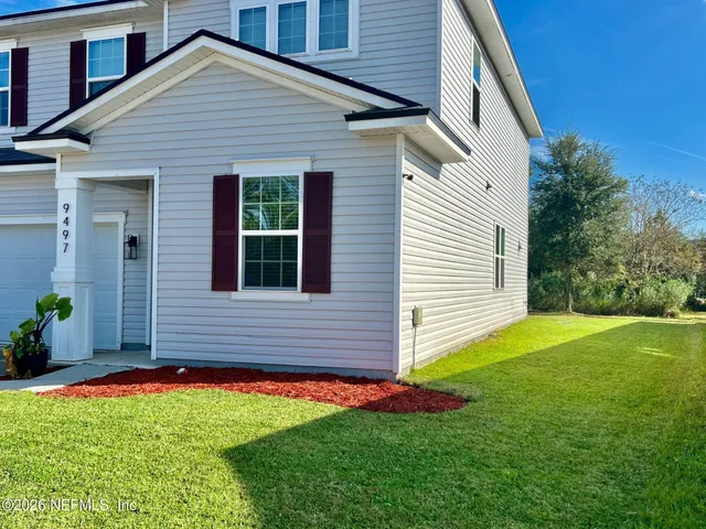 a front view of house with yard and outdoor seating