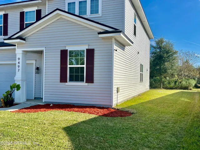 a front view of a house with a yard