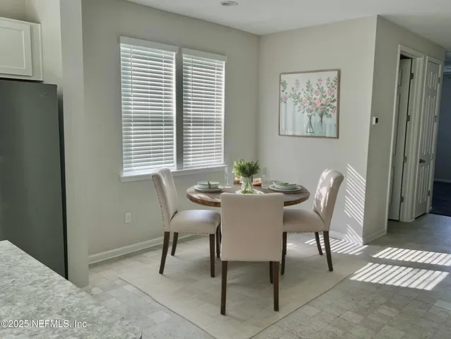 a dining room with furniture and window