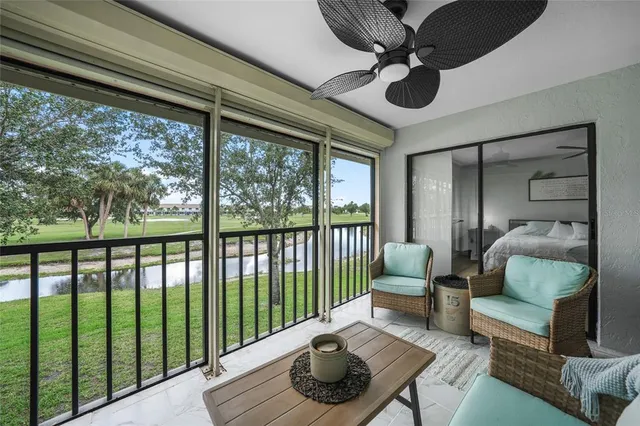 a living room with furniture and a floor to ceiling window