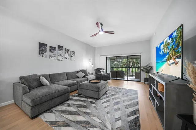 a living room with furniture large window and a flat screen tv