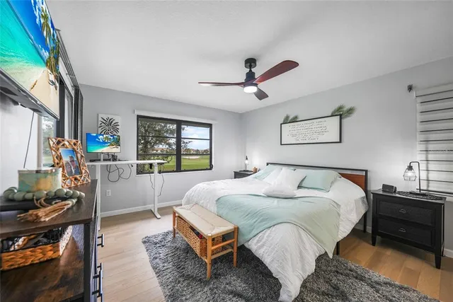 a spacious bedroom with a bed a couch and a window