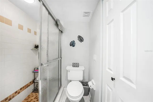 a bathroom with a toilet and a shower