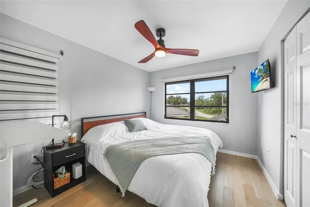 a bedroom with a bed and a window