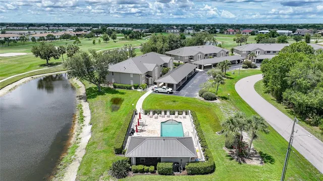 an aerial view of a house with a garden and lake view