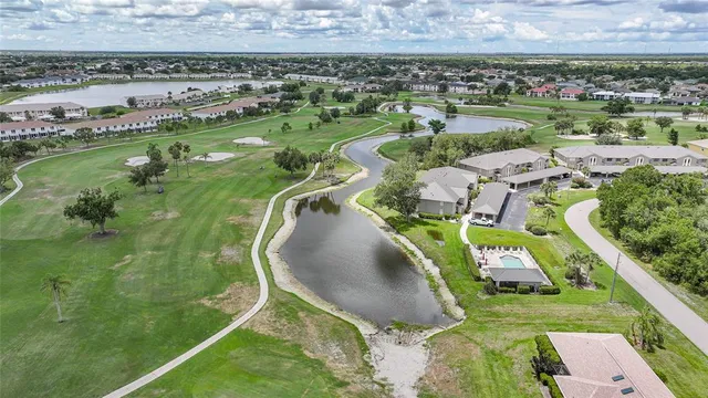 an aerial view of a house with a garden and lake view