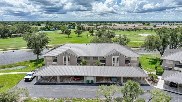 a aerial view of a house with a yard table and chairs