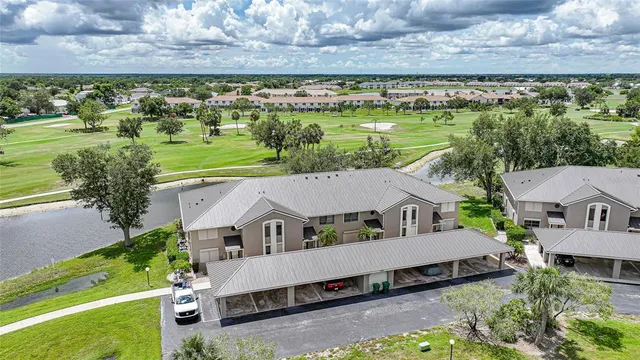 an aerial view of a house with a garden and lake view