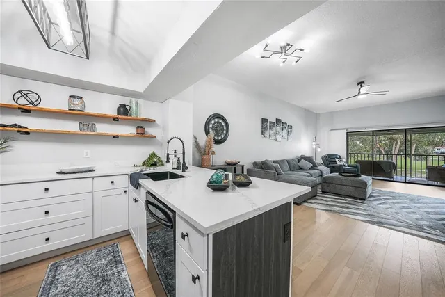 a view of a kitchen with a sink and living room