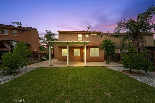 a view of a house with a yard and plants