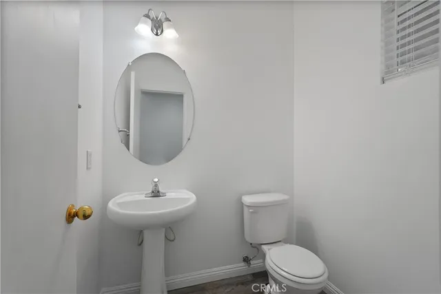 a view of empty room with wooden floor and window