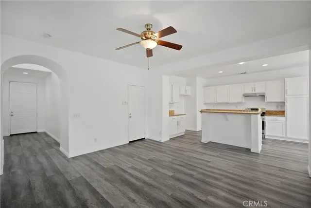 a view of empty room with wooden floor and fireplace