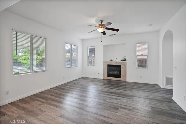 a kitchen with granite countertop a white stove top oven and white cabinets