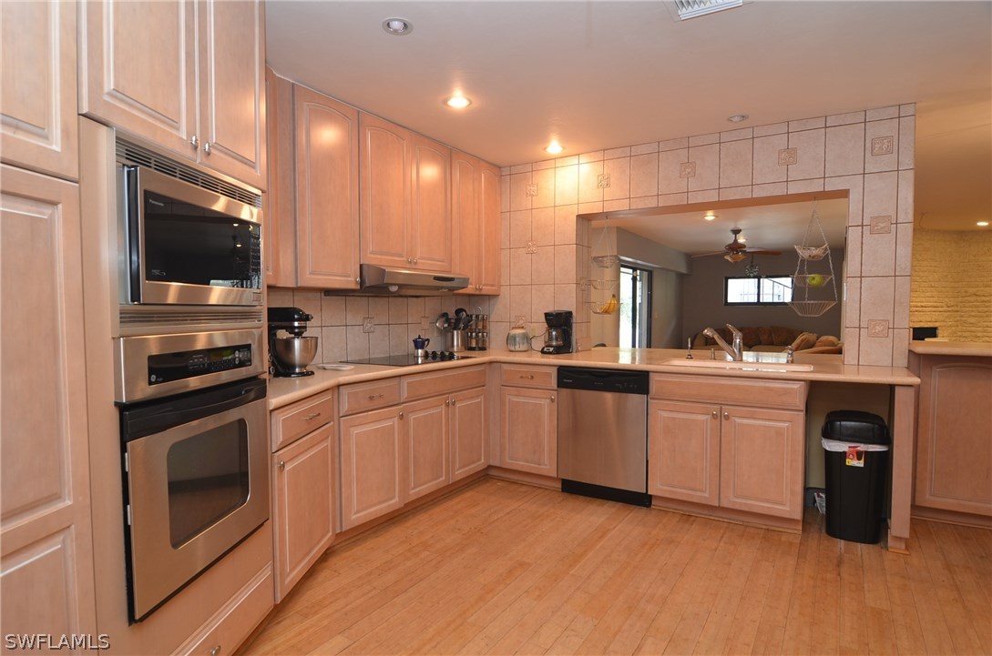 8312 Riviera Avenue Fort Myers, FL 33919 - Photo 12 of 24 a kitchen with white cabinets and appliances