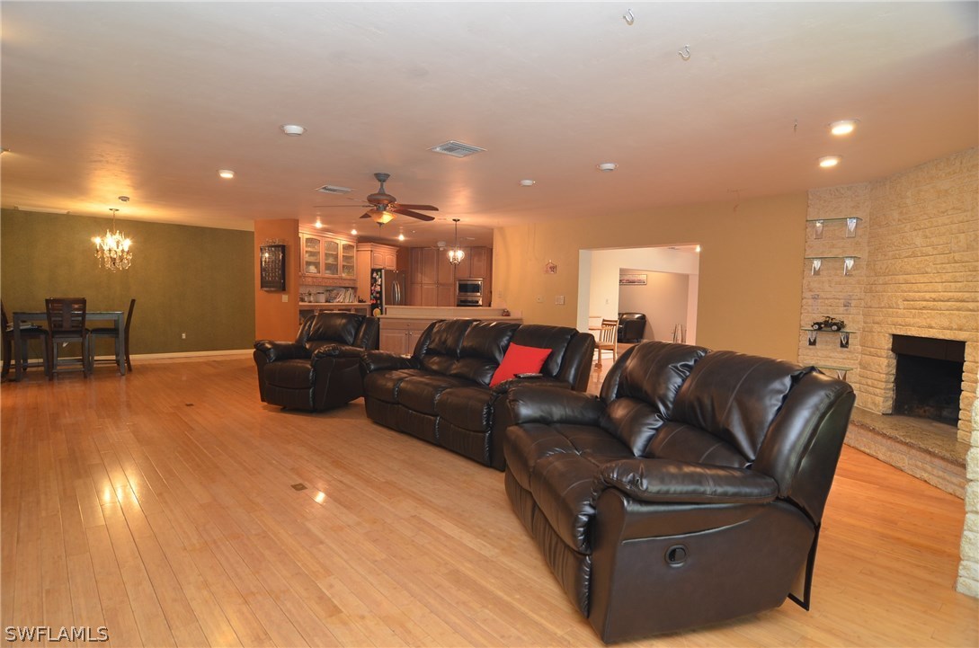 8312 Riviera Avenue Fort Myers, FL 33919 - Photo 13 of 24 a living room with furniture and a chandelier