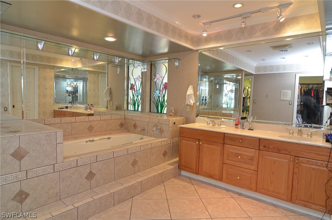 8312 Riviera Avenue Fort Myers, FL 33919 - Photo 15 of 24 a spacious bathroom with a granite countertop sink mirror and bathtub