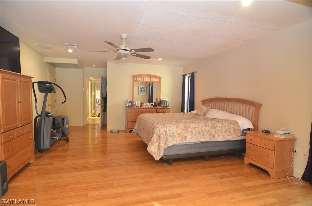 8312 Riviera Avenue Fort Myers, FL 33919 - Photo 16 of 24 a bedroom with a bed and a mirror