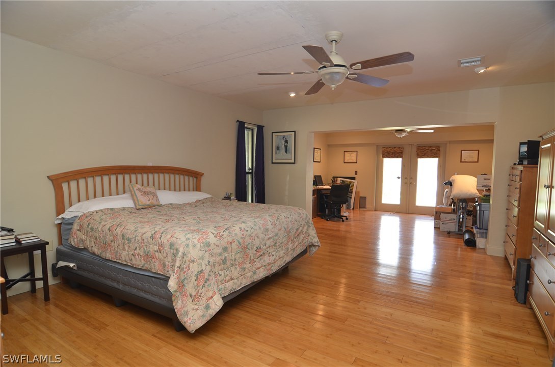 8312 Riviera Avenue Fort Myers, FL 33919 - Photo 17 of 24 a bedroom with a bed and wooden floor