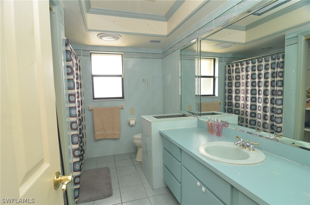 8312 Riviera Avenue Fort Myers, FL 33919 - Photo 21 of 24 a bathroom with a sink toilet and shower