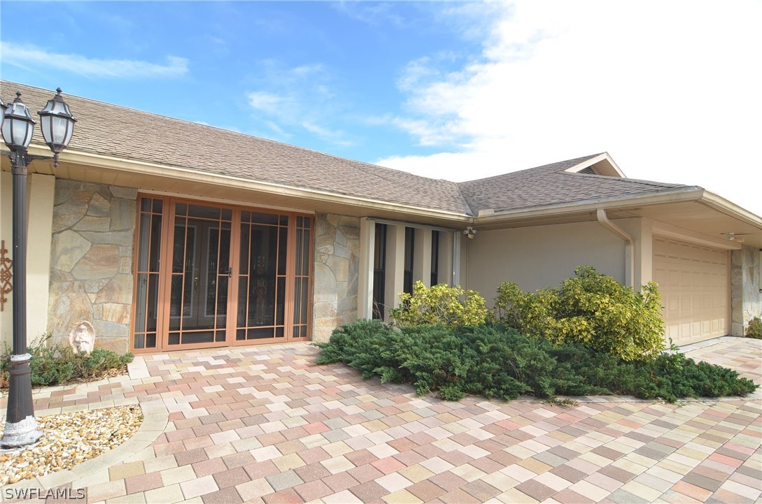 8312 Riviera Avenue Fort Myers, FL 33919 - Photo 3 of 24 a front view of a house with garden