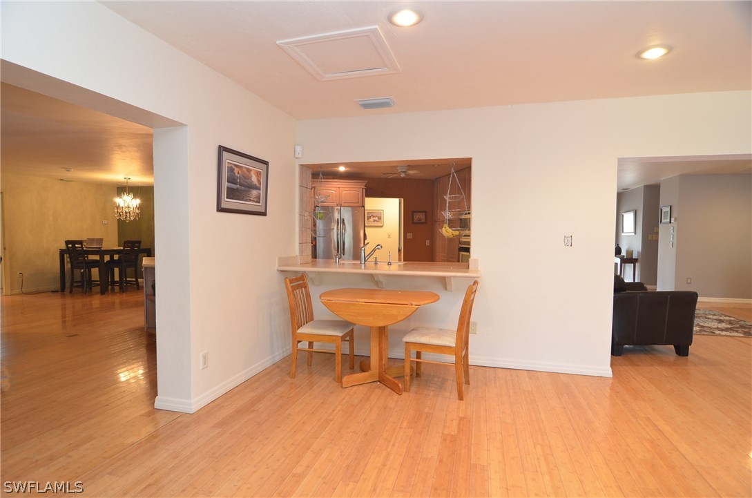 8312 Riviera Avenue Fort Myers, FL 33919 - Photo 8 of 24 a dining room with furniture and wooden floor