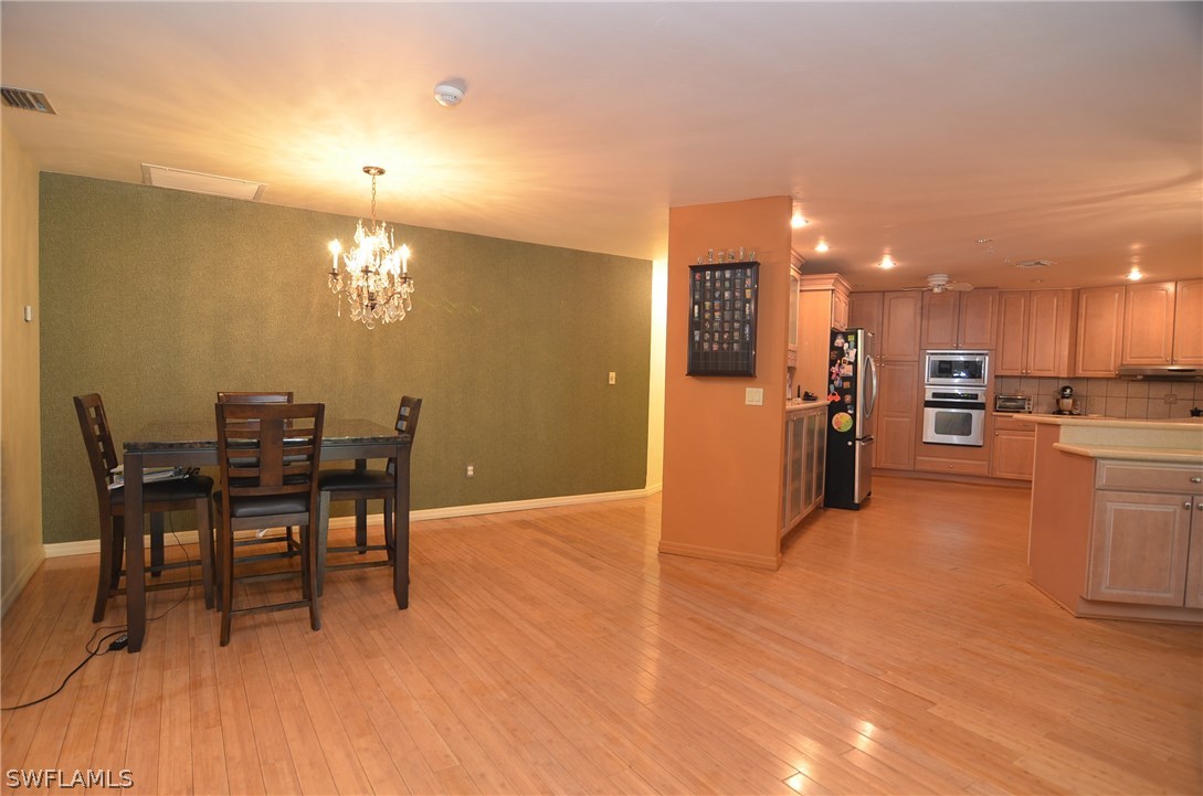 8312 Riviera Avenue Fort Myers, FL 33919 - Photo 10 of 24 a view of a dining room with furniture and chandelier