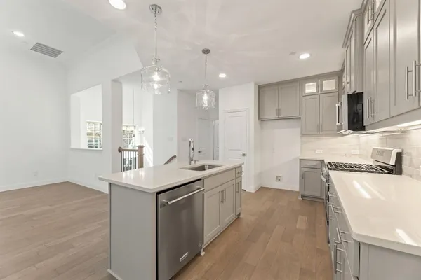 a kitchen with a sink appliances and cabinets