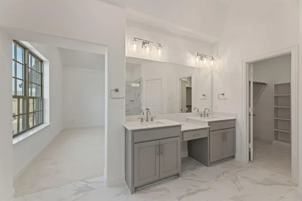 a bathroom with a shower sink and mirror