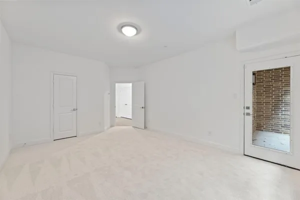 a view of an empty room with glass door